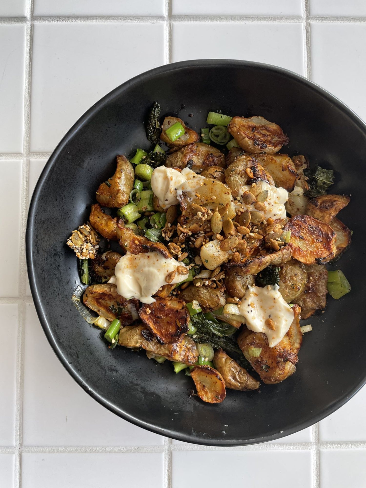 Crispy roasted Jerusalem artichokes with chicken salt, spring onions, aioli and toasted seeds
