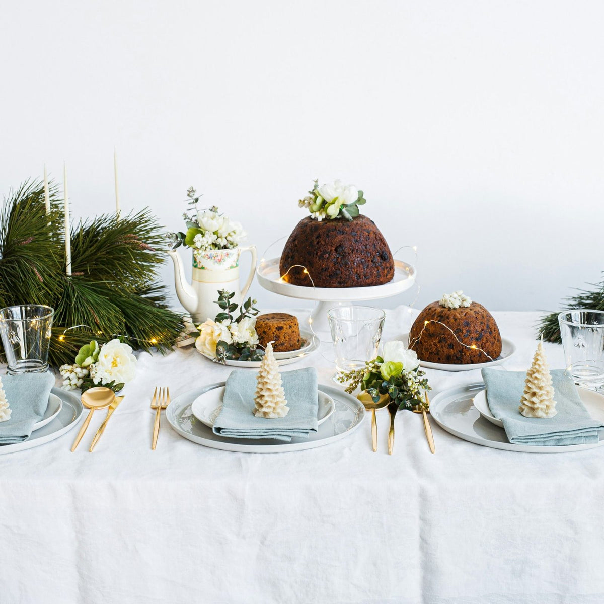Thermomix vegan Christmas puddings on a white cake stand at a festive Christmas table