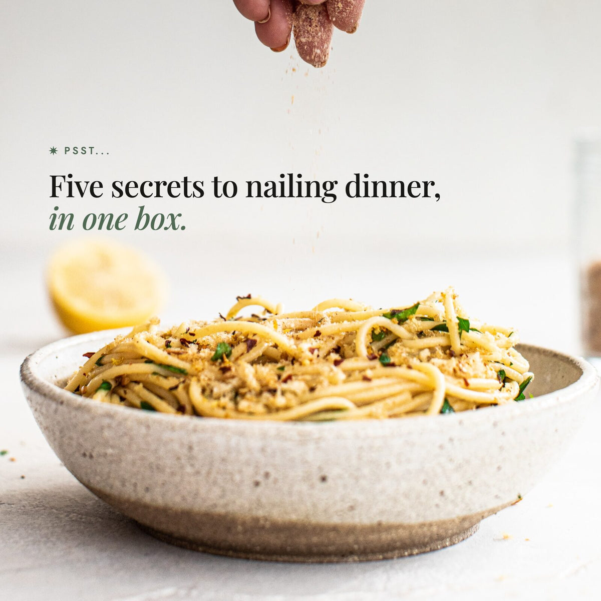 Hand sprinkling seasoning salt over a bowl of spaghetti with lemon; Alyce's Flavour Bombs Starter Pack teaser: psst, five secrets to nailing dinner, in one box