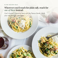 Table of spaghetti bowls with glasses of wine; the golden rule of Alyce's Flavour Bombs Starter Pack: wherever you'd reach for plain salt, reach for one of these instead