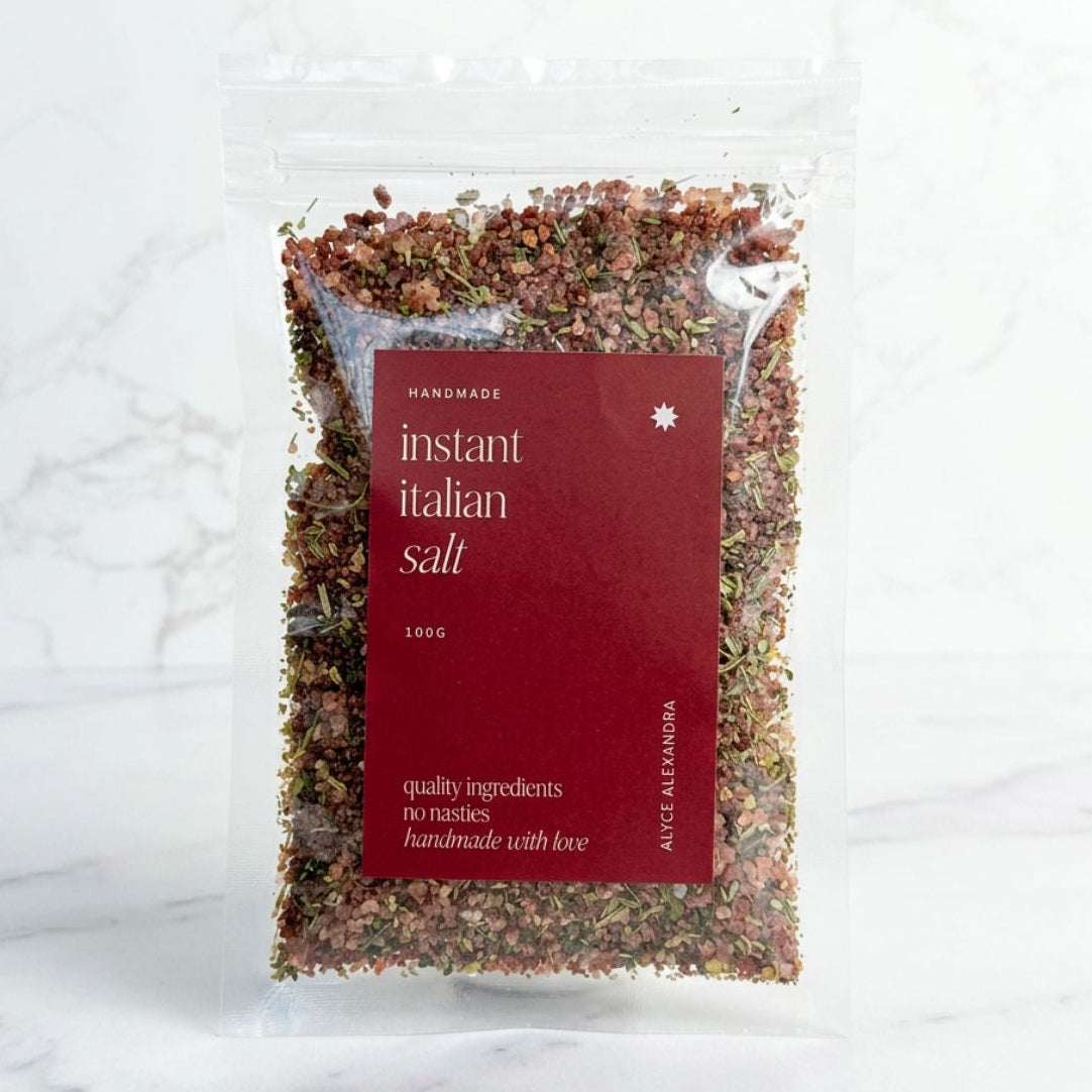 Alyce's Instant Italian Salt 100g bag with red label, the pink salt, tomato and herb blend visible through the clear packet