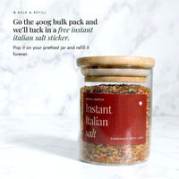 Glass jar of Instant Italian Salt with a bamboo lid on a marble bench; the 400g bulk pack comes with a free Instant Italian Salt sticker to pop on your prettiest jar and refill forever
