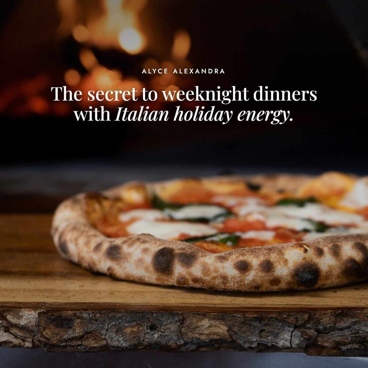 Wood-fired margherita pizza on a timber board in front of a glowing pizza oven; Instant Italian Salt is the secret to weeknight dinners with Italian holiday energy