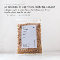 Organic Flavour Bomb Salt packet on a pale bench; no new skills and no long recipes, just better food fast, a big savoury hit of smoky flavour that makes even a thrown-together dinner taste like you tried, from a 100% Australian owned family business