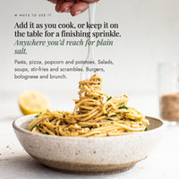 Fork twirling herby spaghetti from a speckled bowl; add Organic Flavour Bomb Salt as you cook or keep it on the table for a finishing sprinkle anywhere you would reach for plain salt, on pasta, pizza, popcorn, potatoes, salads, soups, stir-fries, scrambles, burgers, bolognese and brunch