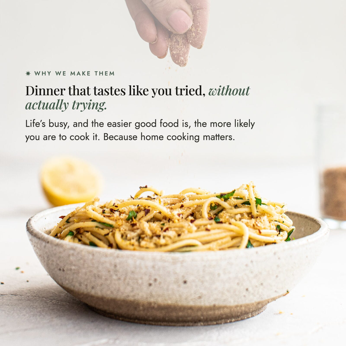 Hand sprinkling Organic Flavour Bomb Salt over a bowl of spaghetti with lemon; dinner that tastes like you tried, without actually trying, because the easier good food is the more likely you are to cook it