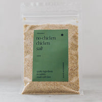 Alyce's Organic No-Chicken Chicken Salt in a clear 100g packet with a sage green label, the pale savoury blend visible through the front