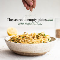 Hand sprinkling Organic No-Chicken Chicken Salt over a bowl of spaghetti; the secret to empty plates and zero negotiation