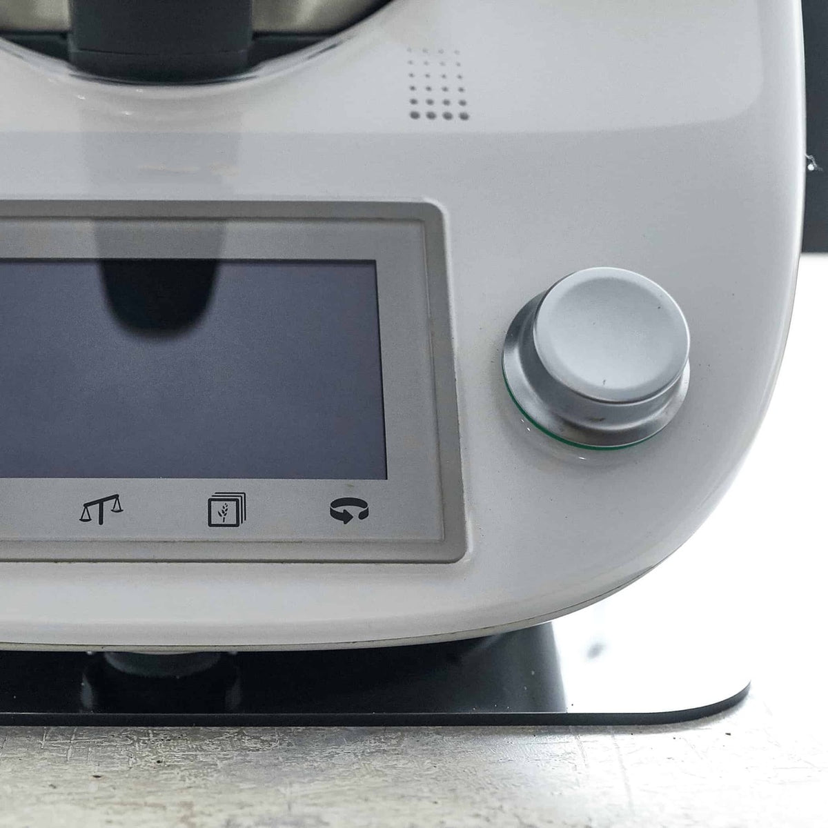 Close-up of the base of a Thermomix TM6 resting on the Appliance Mat on a stone benchtop