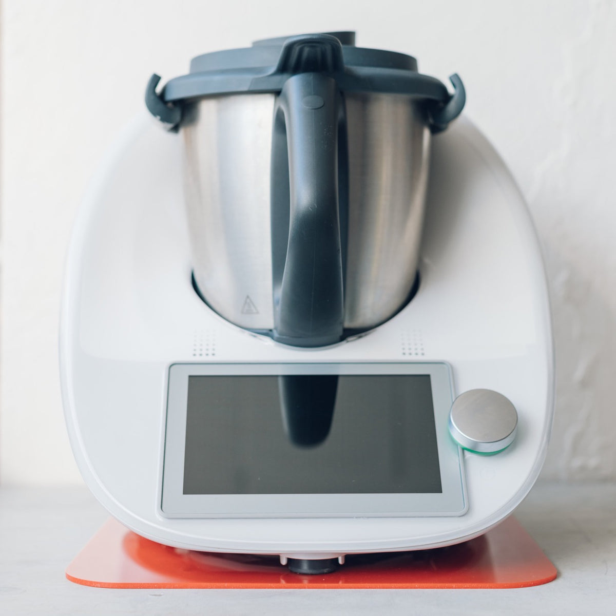 Thermomix sitting on a red Appliance Mat, showing the colour options available