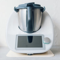 Thermomix on a white Appliance Mat, shown front on against a pale wall
