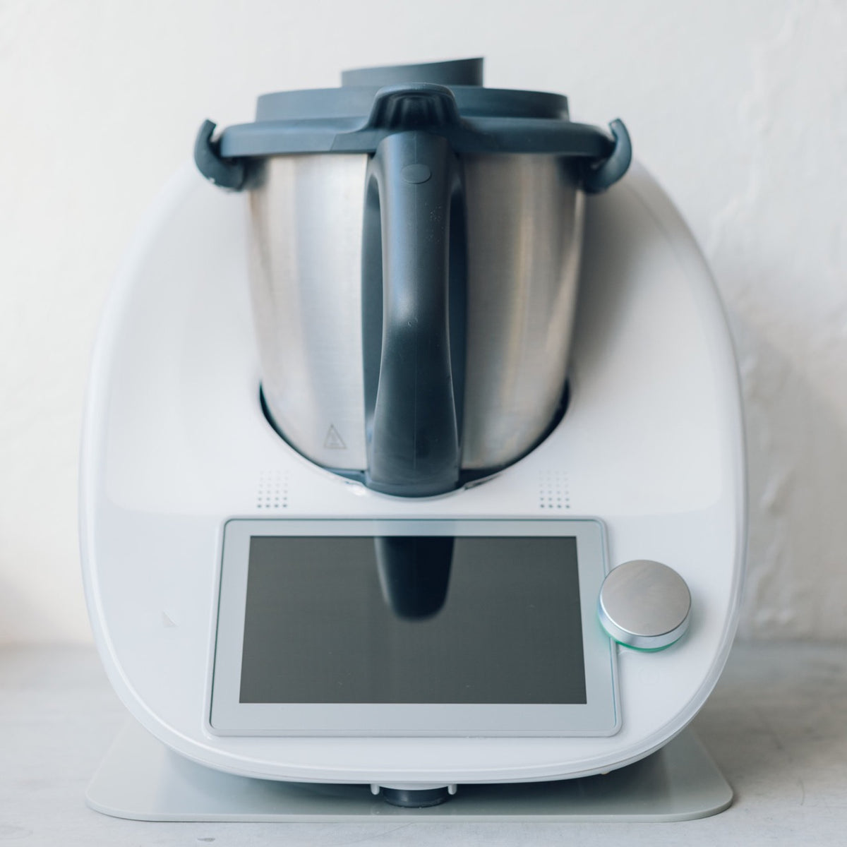 Thermomix on the Appliance Mat with the mat edge just visible beyond the machine's feet