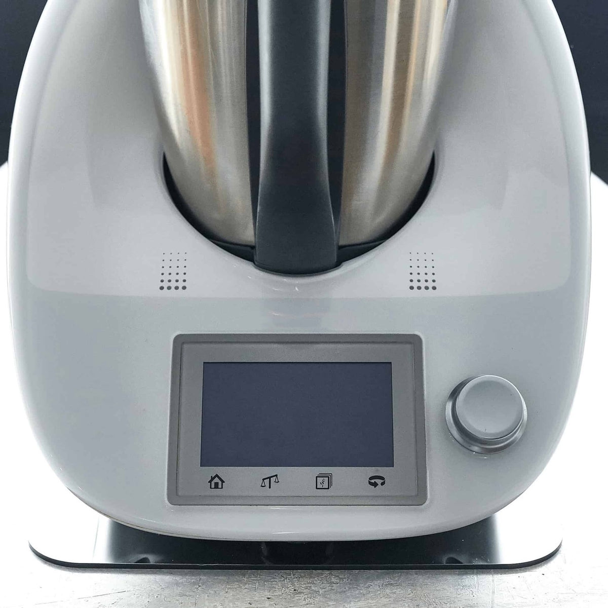 Close-up of the front of a Thermomix TM6 with its touchscreen and dial, sitting on the Appliance Mat