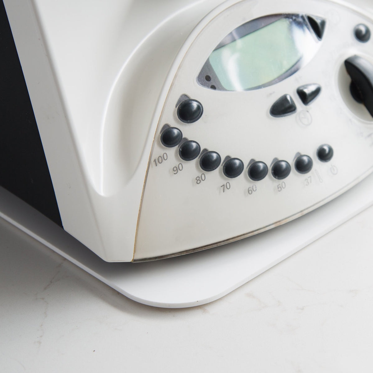 Corner of an older Thermomix TM31 with the Appliance Mat visible beneath its base