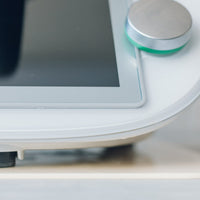 Close-up of a Thermomix base on a cream Appliance Mat, showing how thin the mat sits under the machine