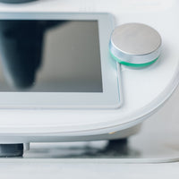 Close-up of a Thermomix base and dial with the Appliance Mat beneath, shown against a light bench