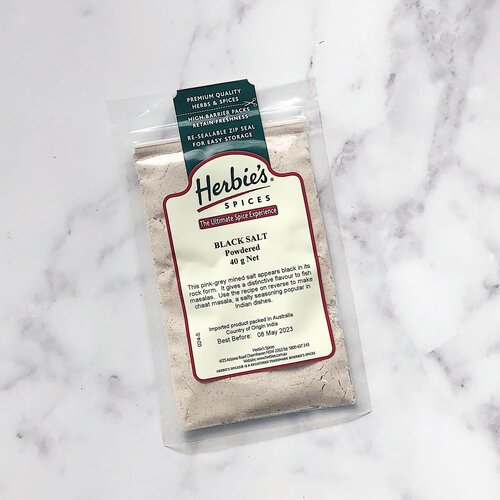 Herbie's Black Salt in its labelled 45g pack on marble