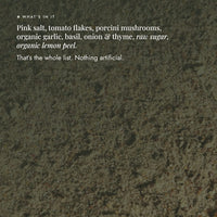 Close-up of Bolognese Boost Salt blend showing its full ingredient list: pink salt, tomato flakes, porcini mushrooms, organic garlic, basil, onion and thyme, raw sugar and organic lemon peel; nothing artificial