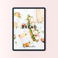 Bread Class Booklet for Thermomix machines shown on a tablet, the cover surrounded by loaves, rolls and filled breads