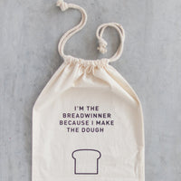 Breadwinner Bread Bag hanging with its drawstring pulled open, printed with the breadwinner slogan and loaf illustration