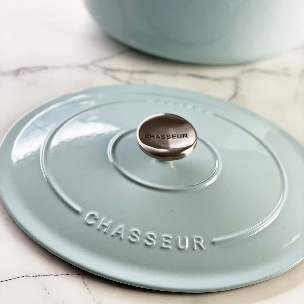 Close-up of the Chasseur lid showing the brand name and the metal knob