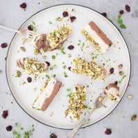 Platter of sliced meat topped with a herb and pistachio crust, from the Christmas Class Booklet for Thermomix machines