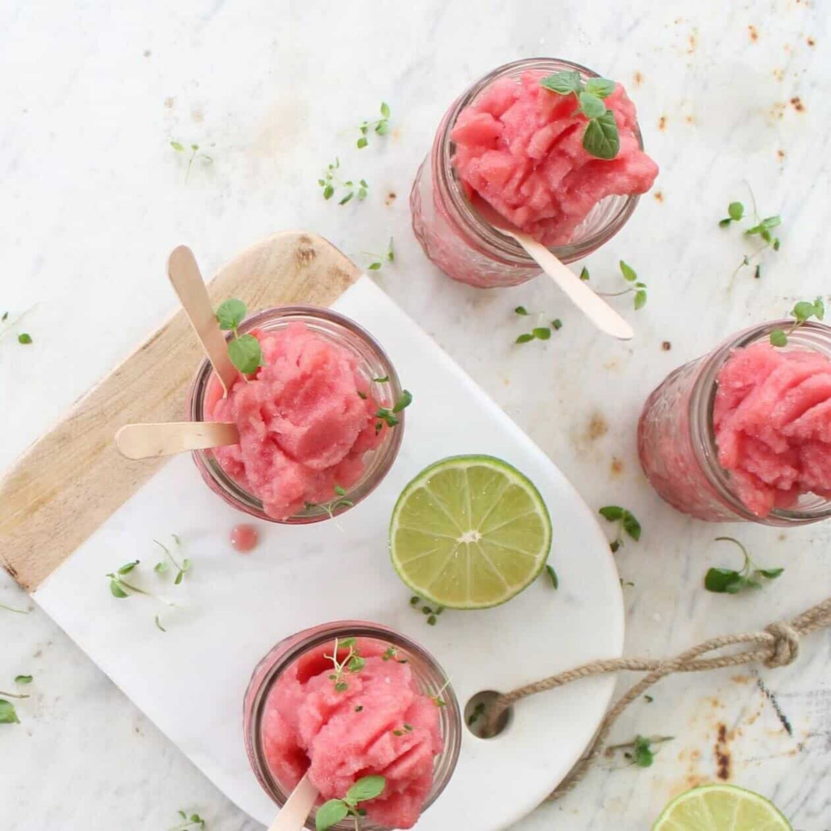 Glasses of raspberry granita with lime and mint, served with wooden spoons, from the Christmas Class Booklet