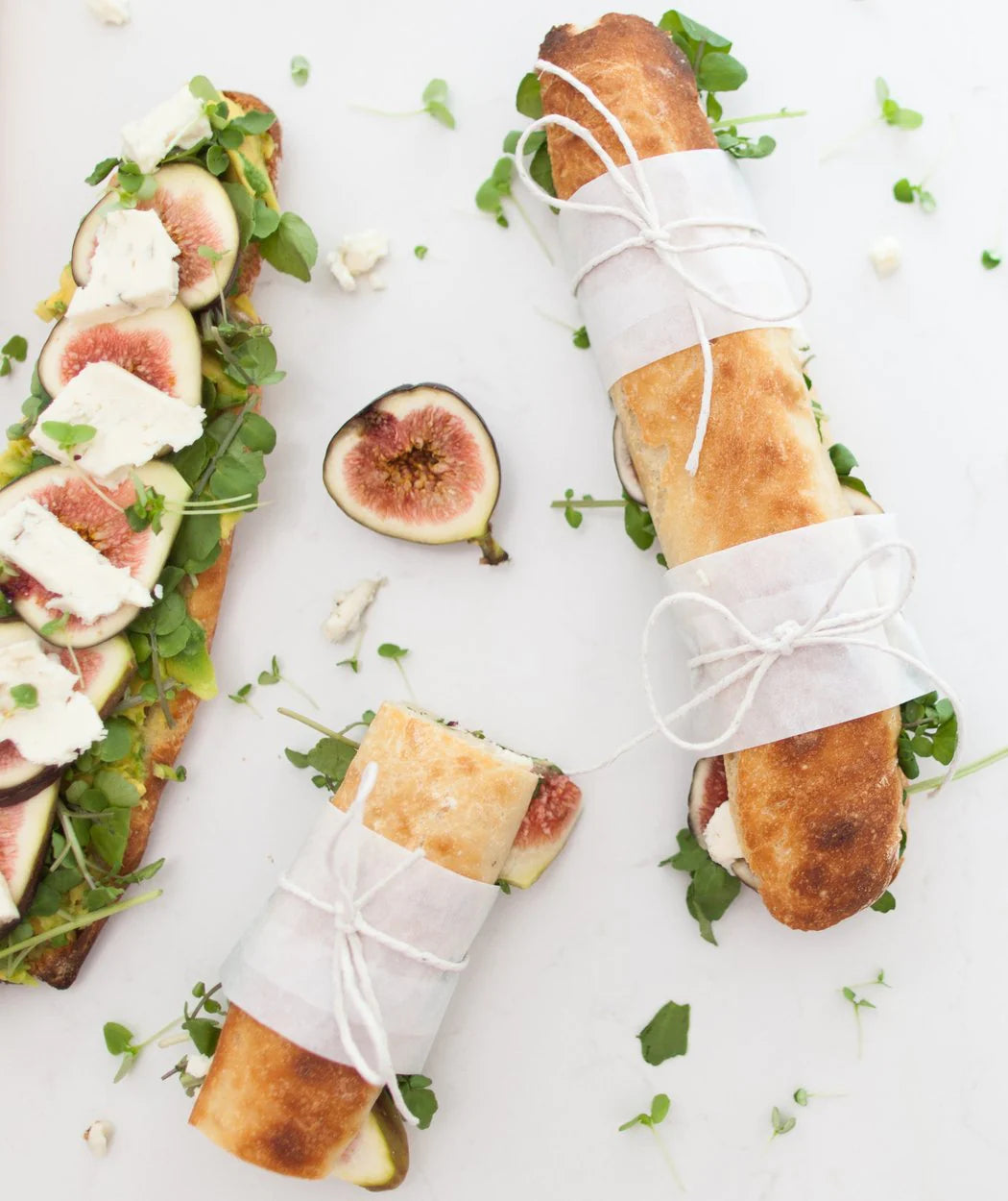 Fig and prosciutto baguettes tied with string beside open sandwiches topped with figs and greens, from the Class Booklet Bundle