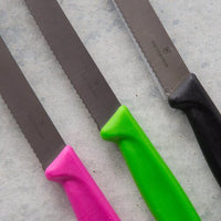 Close-up of three Classic Serrated Knife blades showing the fine serrations