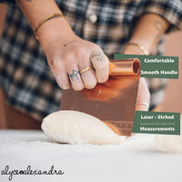 Copper Dough Scraper labelled with its features: a comfortable smooth handle and laser-etched measurements along the blade