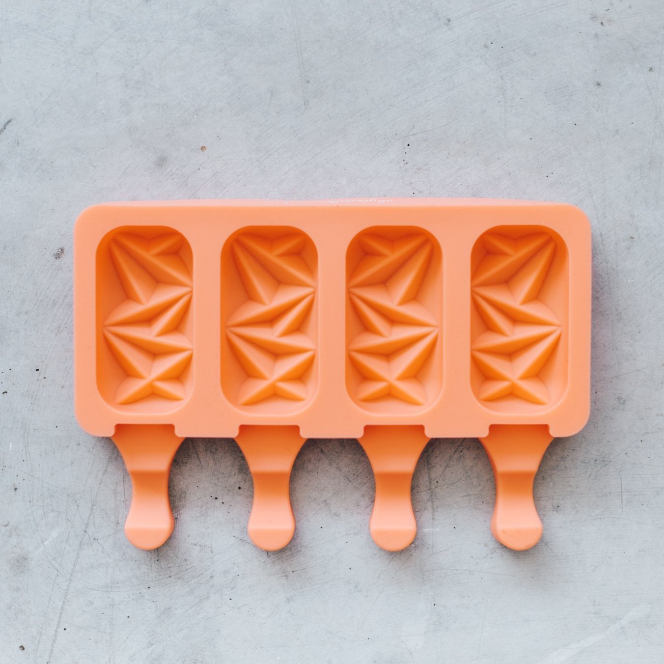 Orange silicone Crystal Ice Cream Mould tray with four faceted cavities and stick slots