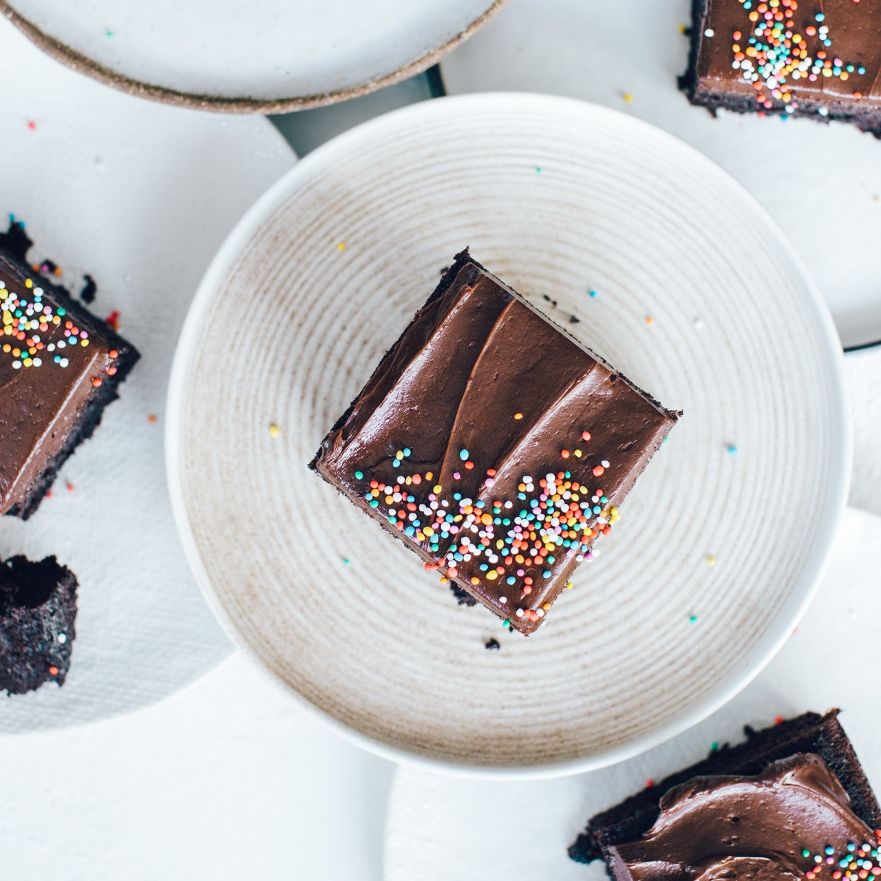 Chocolate slice squares with sprinkles on plates, baked in the Deep Sheet Pan