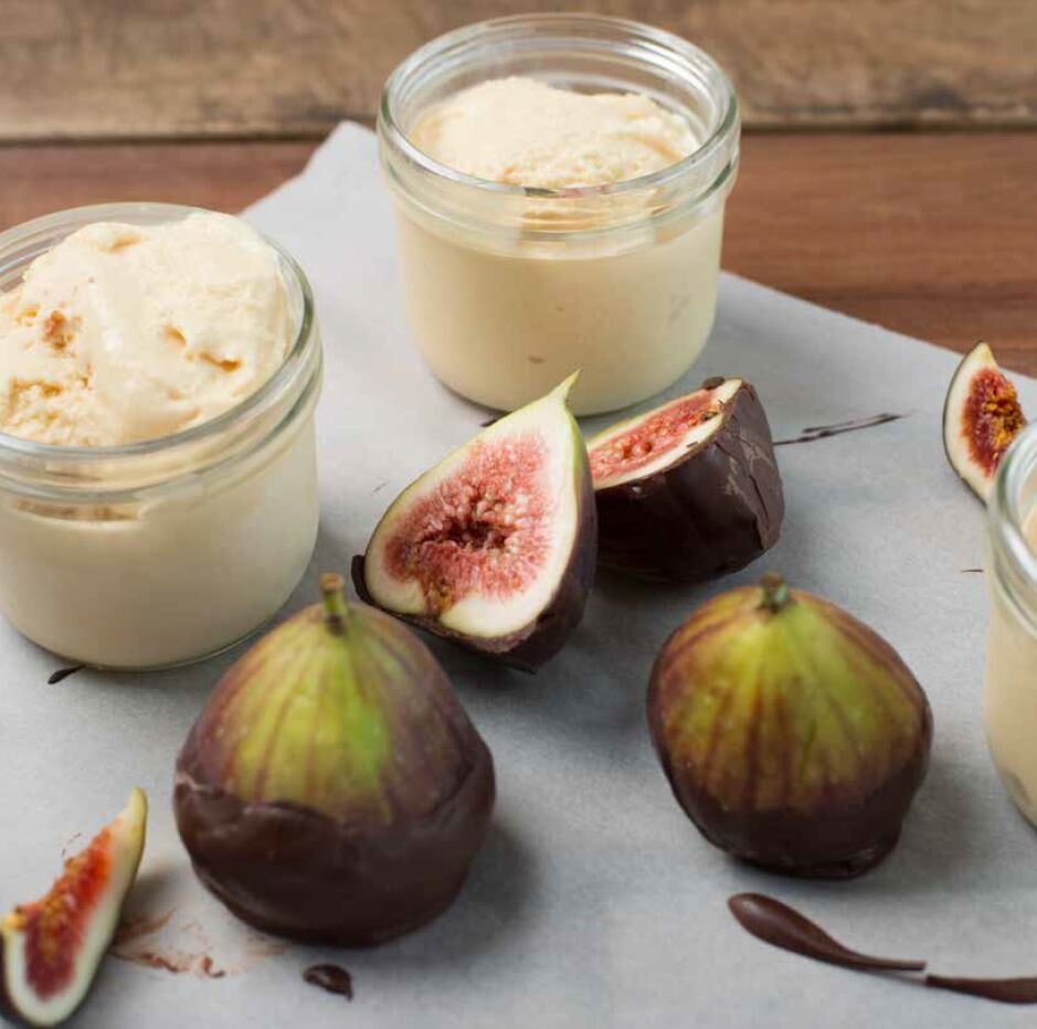 Jars of set panna cotta with fresh figs alongside, from the Desserts Class Booklet