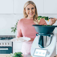 Alyce serving from the Varoma of her Thermomix in a bright kitchen