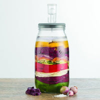 Fermentation Set jar layered with colourful vegetables, with the airlock fitted