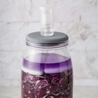 Fermentation Set jar of red cabbage with the ceramic weight holding the vegetables under the brine