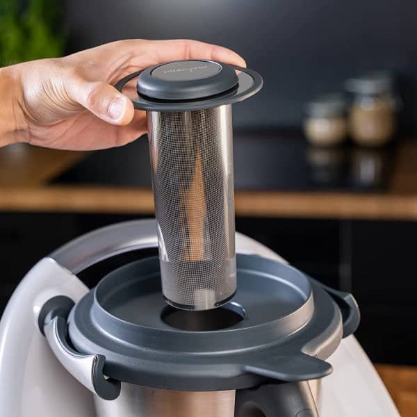 Filtix Thermo Tea Filter seated in the Thermomix lid, its stainless mesh cylinder visible above the bowl
