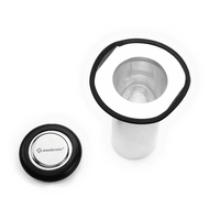 Filtix Thermo Tea Filter shown in parts against a dark green background, the mesh cylinder, the seal and the lid