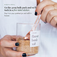 Copper spoon in a glass refill jar of flavour salt; the 400g bulk pack includes a free label sticker to pop on your own jar and refill forever