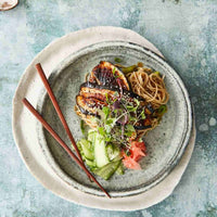 Bowl of noodles with glazed tofu, pickles and greens, served with chopsticks, from Hearty Vegan Thermo Cooked