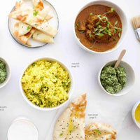 Spread of Indian dishes from the class booklet: curry, yellow rice pilaf, naan bread and a green chutney