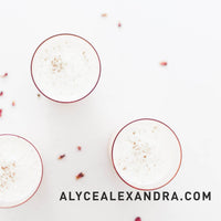 Bowls of Indian dessert topped with rose petals and coconut on a pale surface, from the Indian Class Booklet
