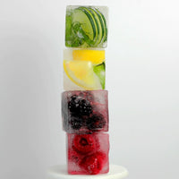 Stacked jumbo ice cubes with lime, lemon and berries frozen inside