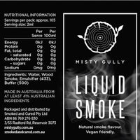 Nutritional and ingredient panel for Misty Gully Liquid Smoke: ingredients are water, wood smoke, emulsifier 433 and buffer 500ii, made in Australia from at least 4% Australian ingredients, with no energy, protein, fat, carbohydrate, sugars or sodium per 2 ml serve