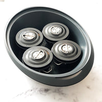 Four Mini Non-Stick Steamers with their lids on, sitting inside the Thermomix Varoma tray