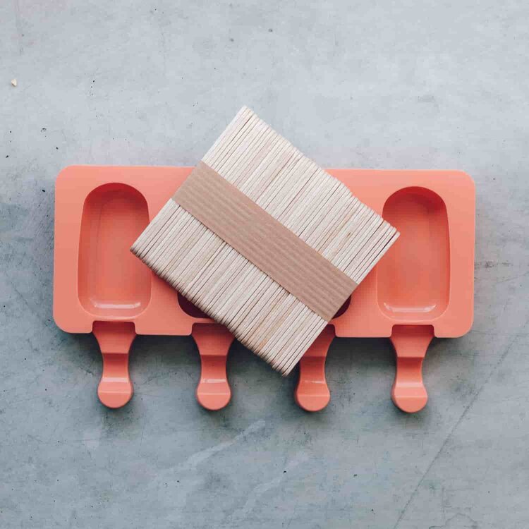 Mini Silicone Ice Cream Mould tray with the free bundle of wooden sticks resting across it