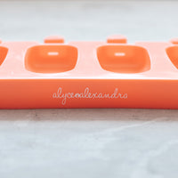 Close-up of the terracotta Mini Silicone Ice Cream Mould tray with the alyce alexandra name embossed on the side