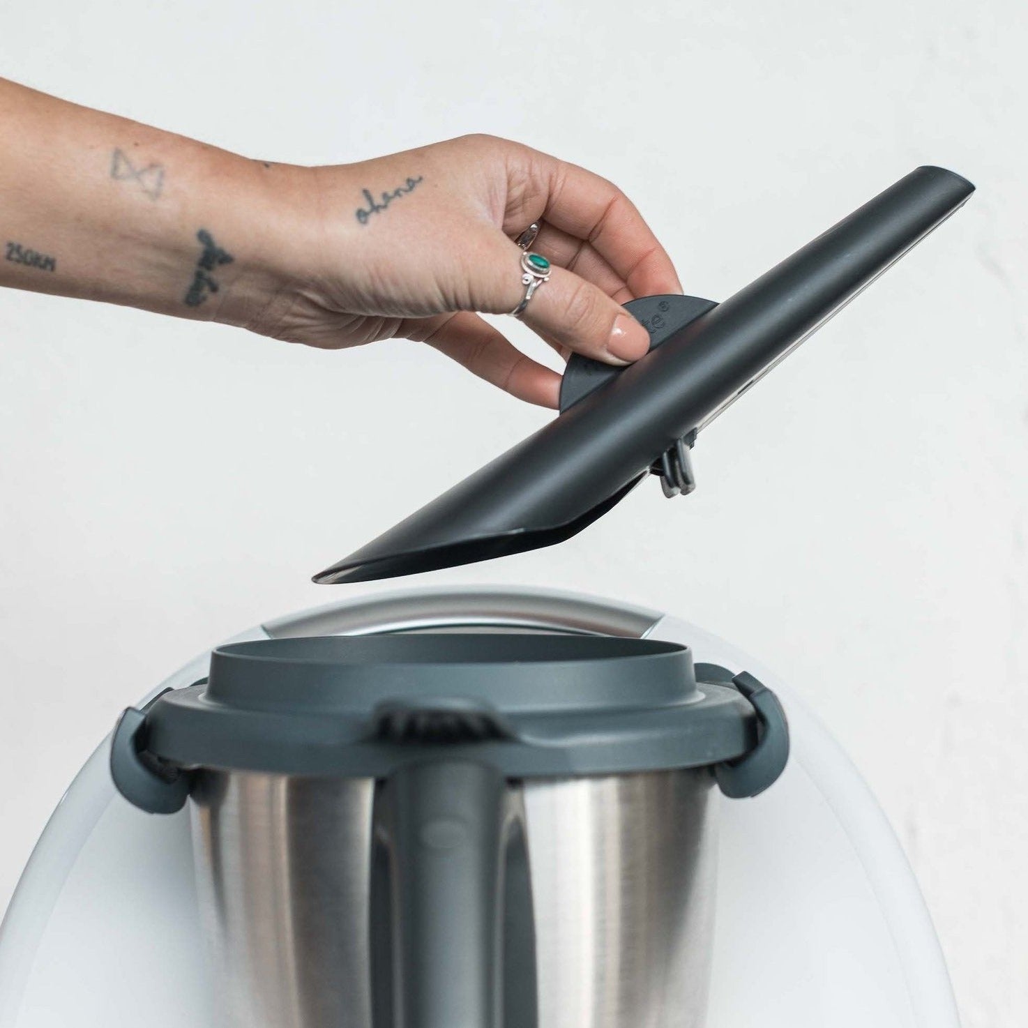 Hand fitting the MixTaste Thermo Chimney onto the lid of a Thermomix