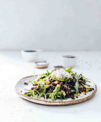 Platter of slow cooked greens and salad scattered with seeds, from Modern Slow Cooker