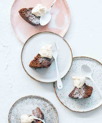 Slices of dense slow cooked loaf served with cream on plates, from Modern Slow Cooker